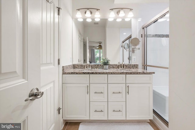 bathroom featuring plus walk in shower, tile patterned flooring, vanity, and ceiling fan