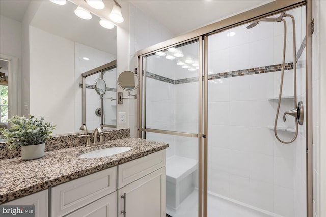 bathroom with a stall shower and vanity