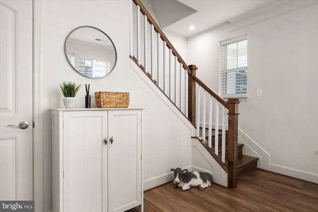 stairway with hardwood / wood-style flooring and crown molding