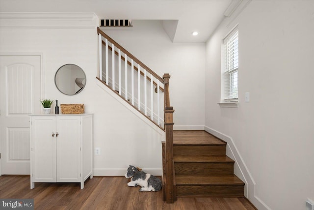 stairs featuring visible vents, baseboards, wood finished floors, and recessed lighting