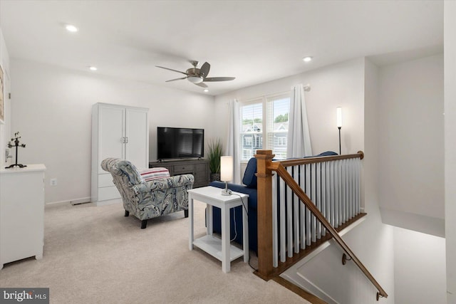 living room featuring ceiling fan, recessed lighting, baseboards, and light colored carpet