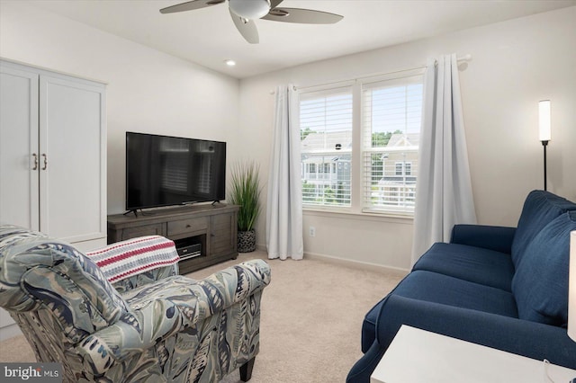 carpeted living room with ceiling fan and a wealth of natural light