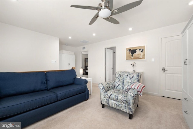 living room with ceiling fan and light colored carpet