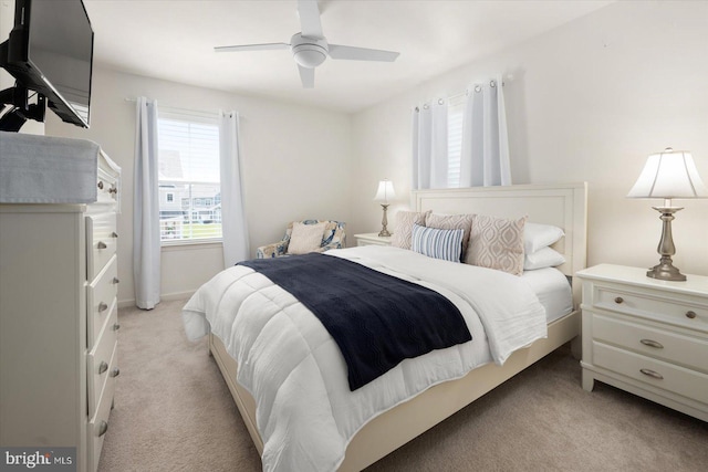 bedroom featuring a ceiling fan and light carpet