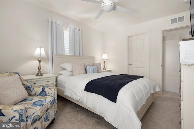 bedroom featuring ceiling fan, visible vents, and light colored carpet