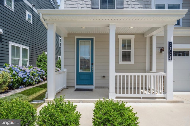 entrance to property with a garage and a porch