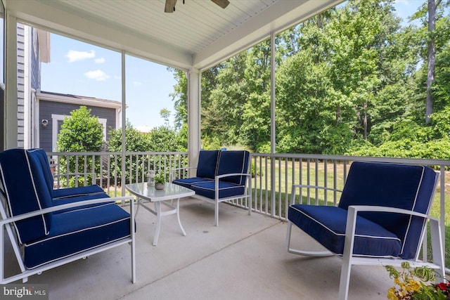 sunroom featuring ceiling fan