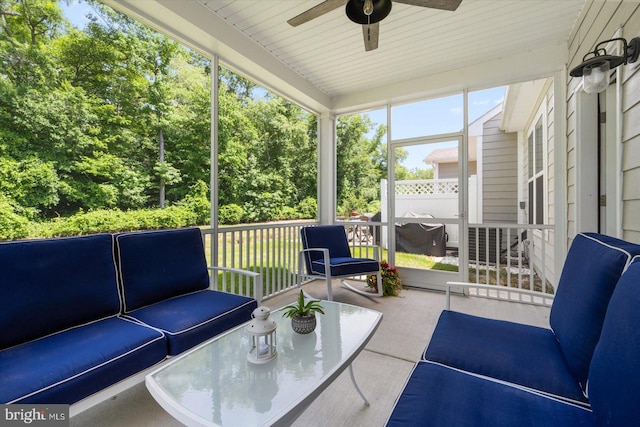 sunroom / solarium with a ceiling fan