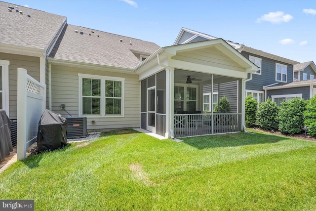 back of house with roof with shingles, a yard, a ceiling fan, a sunroom, and cooling unit