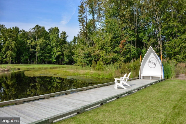 view of dock featuring a water view and a lawn