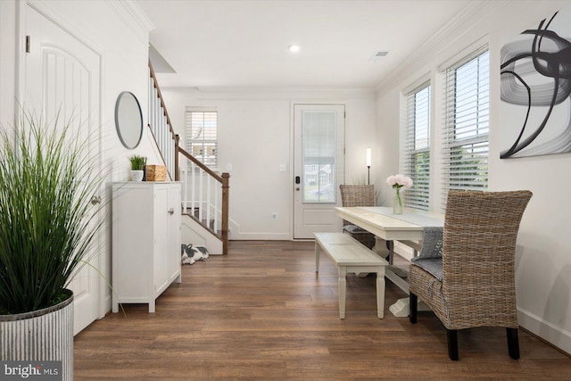 dining room with crown molding, dark wood-type flooring, and a wealth of natural light