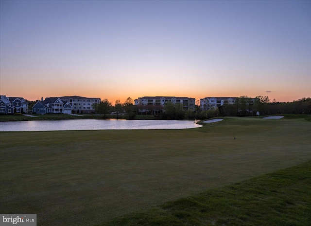 surrounding community featuring a yard, a water view, and a residential view