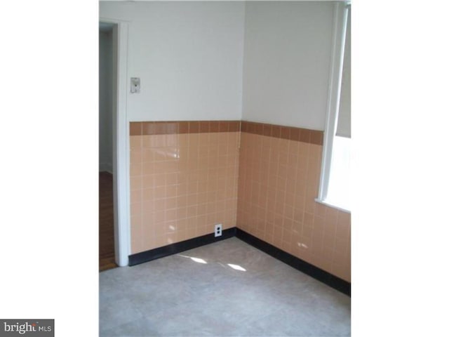 empty room with tile walls