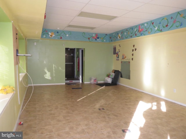 empty room featuring a paneled ceiling