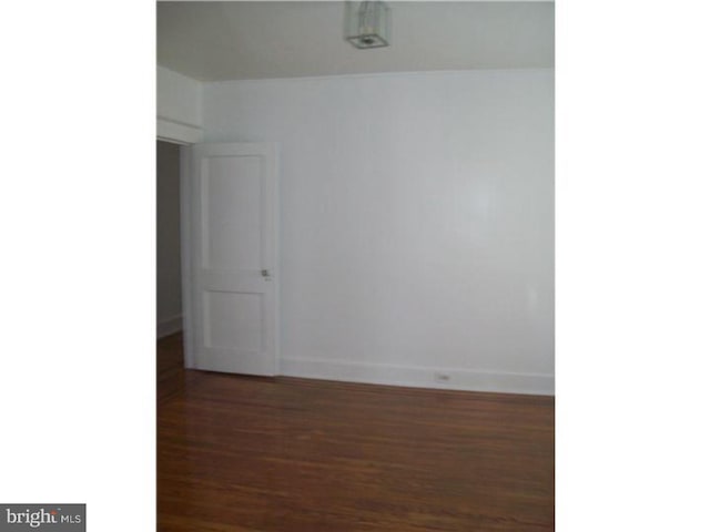 unfurnished room featuring dark hardwood / wood-style flooring