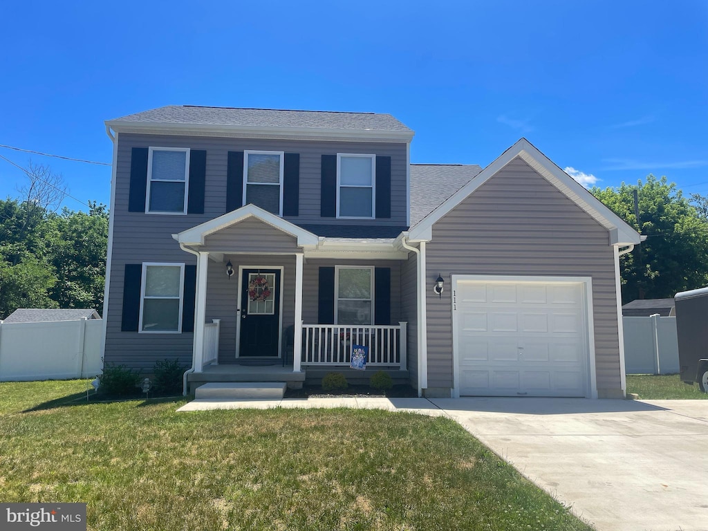 view of front of house featuring a porch, a garage, and a front lawn