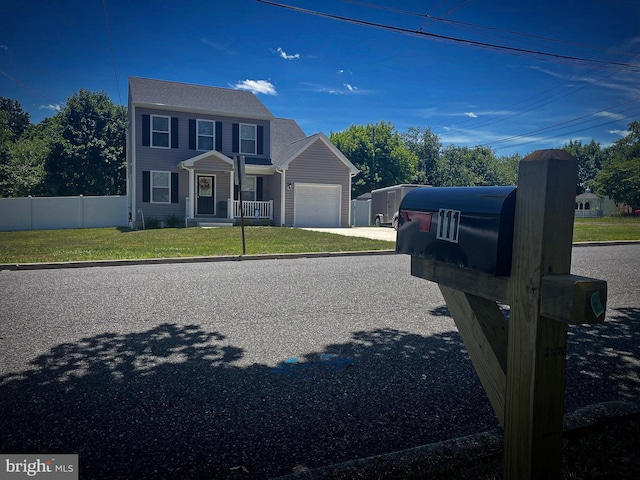 view of front of home featuring a front yard and a garage