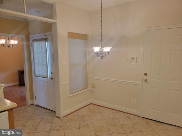 unfurnished dining area with a notable chandelier and light tile patterned floors