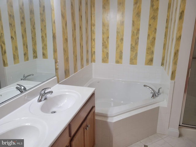 bathroom with tile patterned floors, vanity, and independent shower and bath