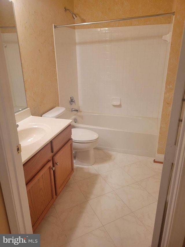 full bathroom featuring tile patterned flooring, tiled shower / bath combo, toilet, and vanity