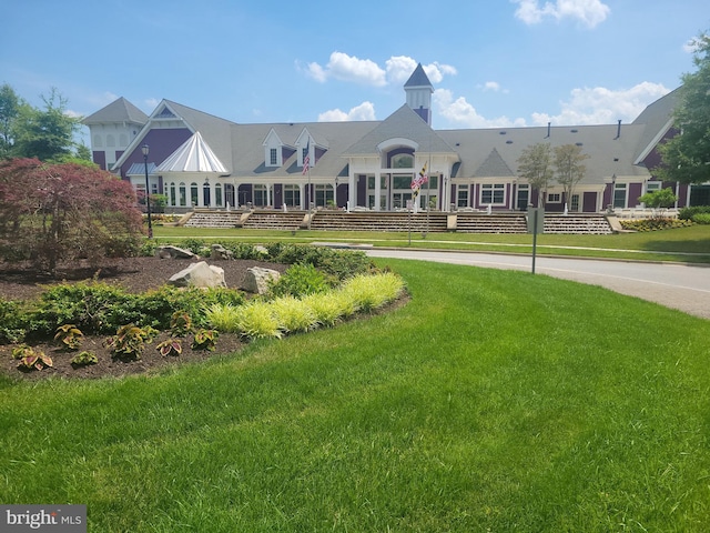 view of property's community with a lawn