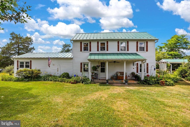 view of front of property with a front yard, a porch, and ceiling fan