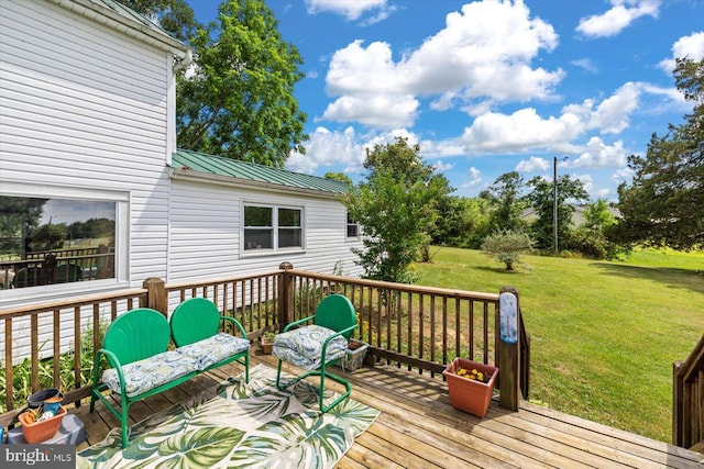 wooden terrace with a lawn