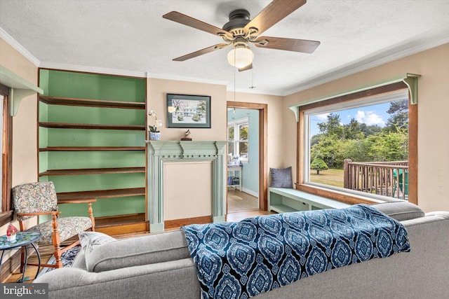 bedroom with a textured ceiling, ceiling fan, and ornamental molding