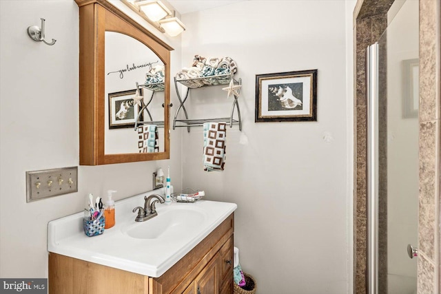 bathroom with vanity and a shower with shower door