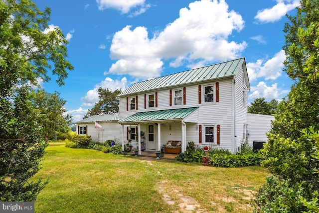 view of front of house featuring covered porch and a front lawn