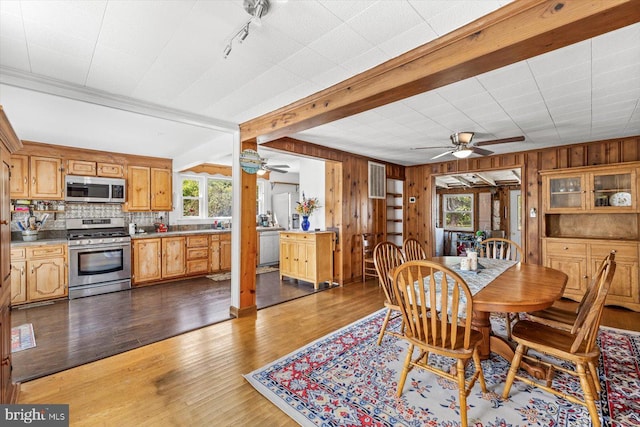 dining room with hardwood / wood-style floors and a healthy amount of sunlight