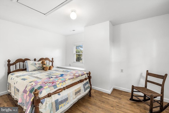 bedroom with hardwood / wood-style flooring