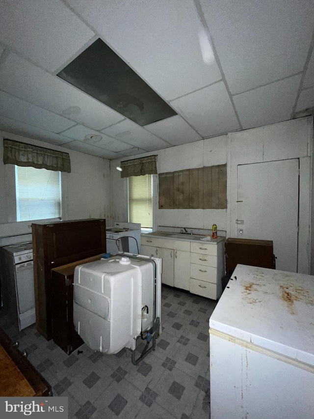 kitchen with white cabinets and a drop ceiling