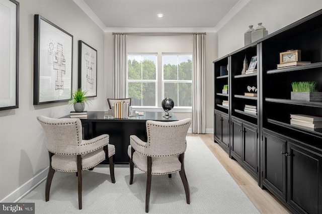 office with light hardwood / wood-style floors and crown molding