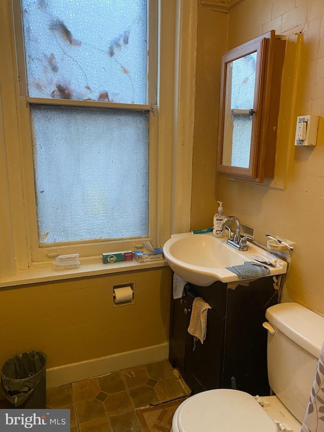 bathroom featuring tile patterned floors, vanity, and toilet