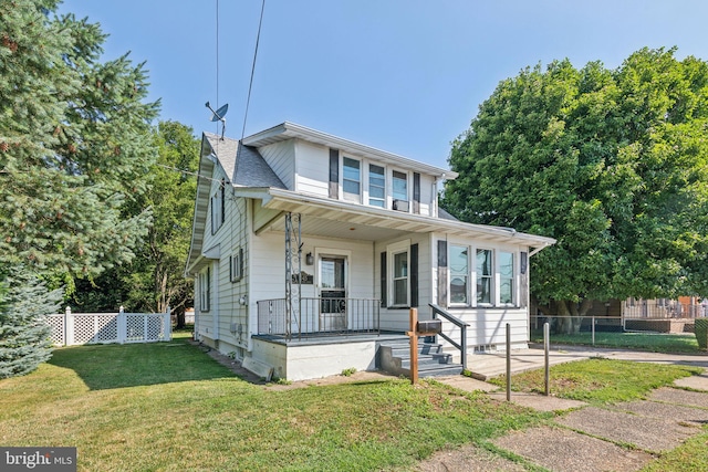 bungalow-style home with covered porch and a front lawn