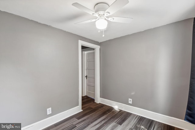 empty room featuring ceiling fan and dark hardwood / wood-style floors