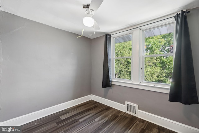 spare room with ceiling fan and wood-type flooring