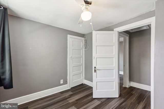 unfurnished bedroom with dark hardwood / wood-style floors and ceiling fan