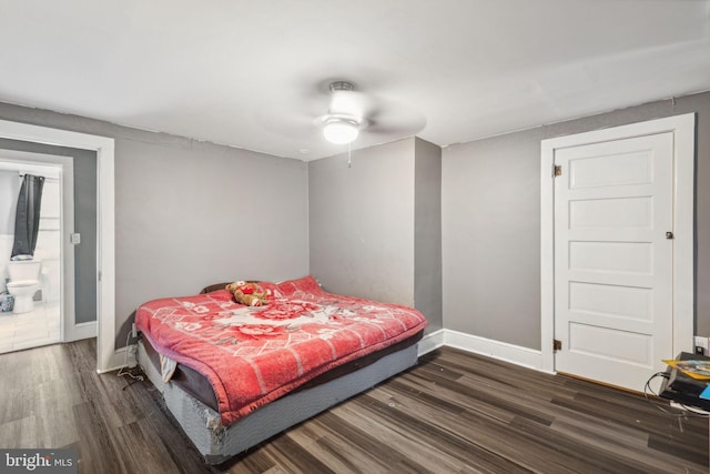 bedroom with ensuite bath, ceiling fan, and dark wood-type flooring