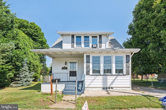 bungalow with a porch and a front lawn