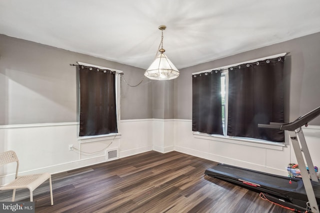 exercise room featuring dark wood-type flooring