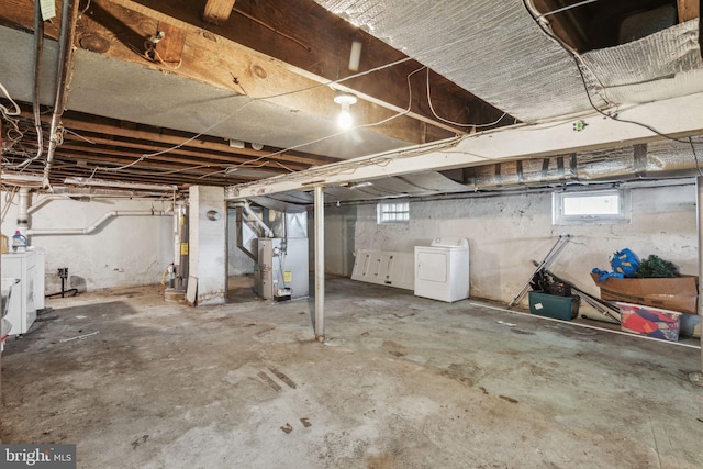 basement with washer / dryer and heating unit