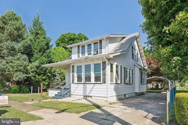 view of side of home with a carport