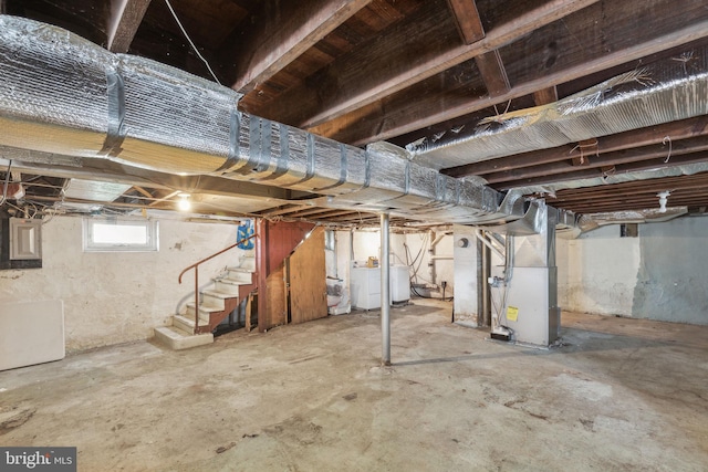 basement featuring washer / dryer, electric panel, and heating unit