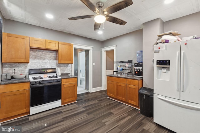 kitchen with white appliances, ceiling fan, dark wood-type flooring, and backsplash