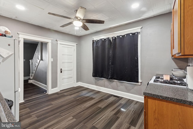 interior space with ceiling fan, white fridge, dark wood-type flooring, and range