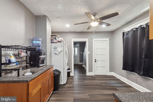 kitchen with white fridge, ceiling fan, and dark wood-type flooring