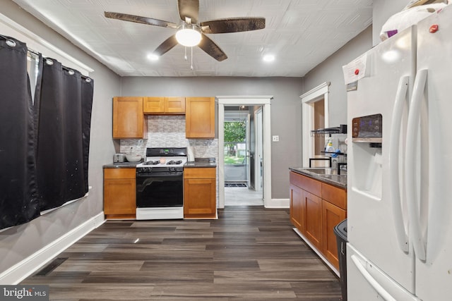 kitchen with white appliances, ceiling fan, dark wood-type flooring, and backsplash