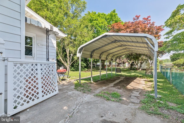 view of vehicle parking featuring a lawn and a carport